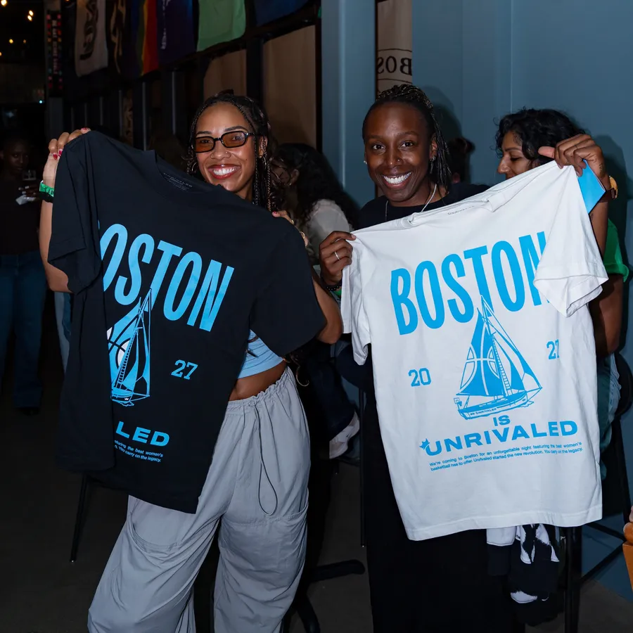 The Boston is Unrivaled tee in black and white, held up under the pennants
