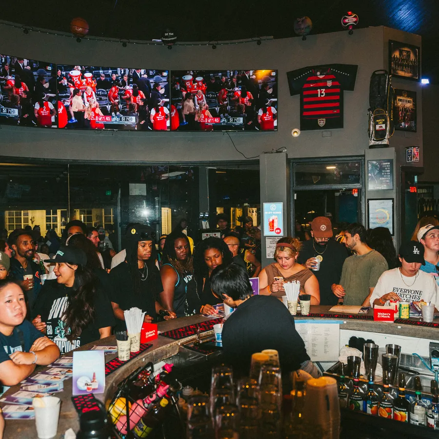 The crowd at Watch Me! under the wall of screens