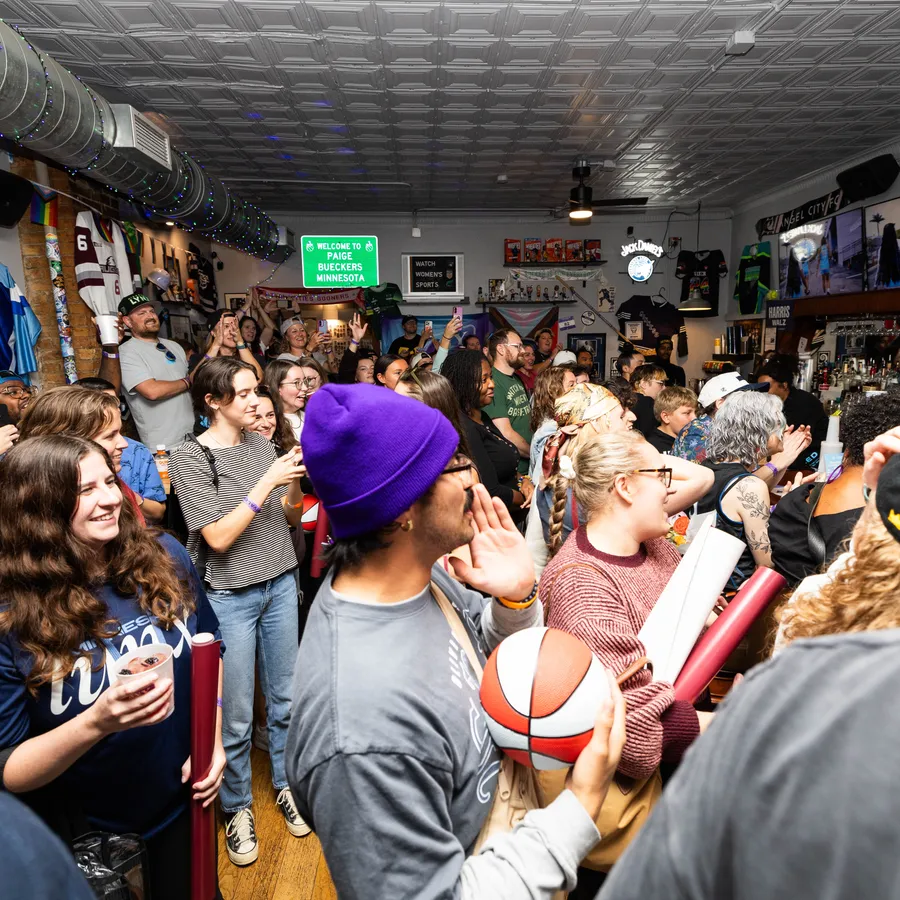 The crowd at A Bar of Their Own under the Welcome to Paige Bueckers Minnesota sign