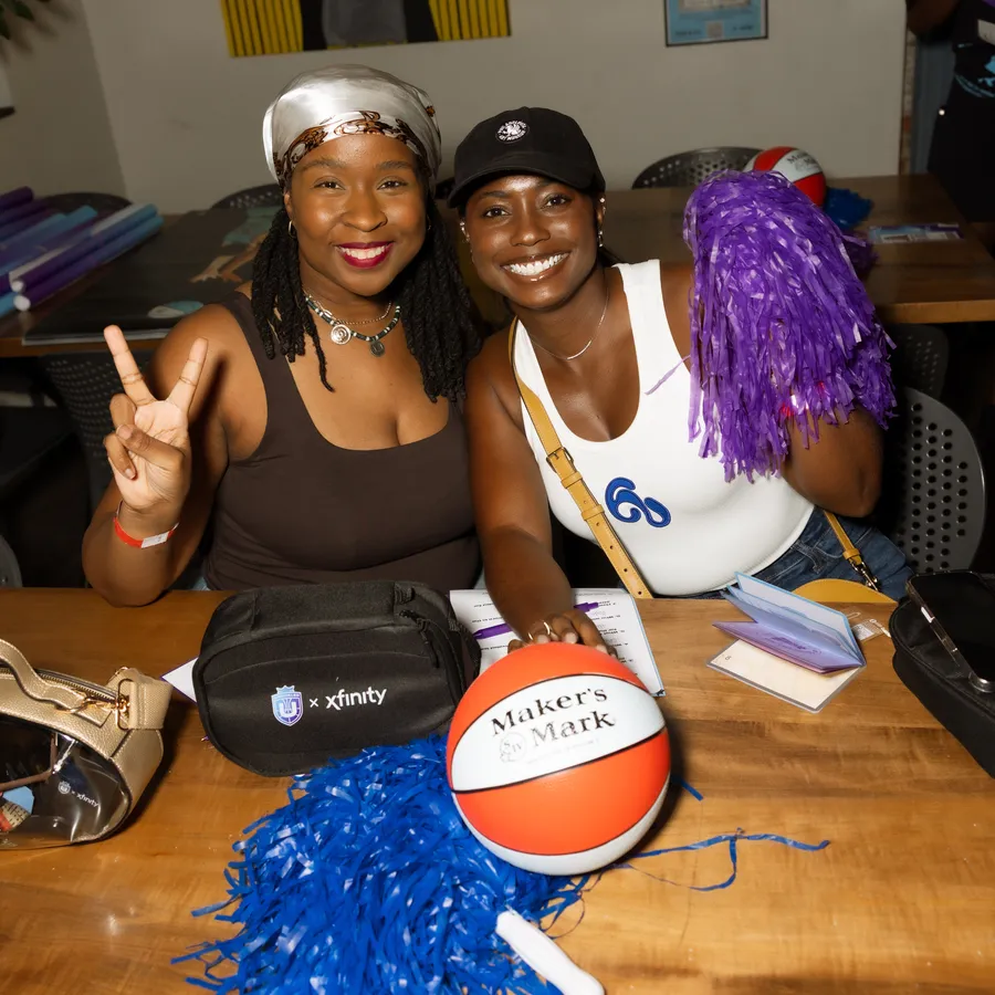 Peace signs and a purple pom, swag bag and Maker’s Mark ball on the table